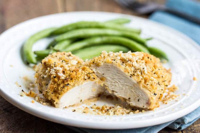 A quick and easy family friendly meal that is packed with flavor and everyone will love! Ritz parmesan chicken on a white plate.