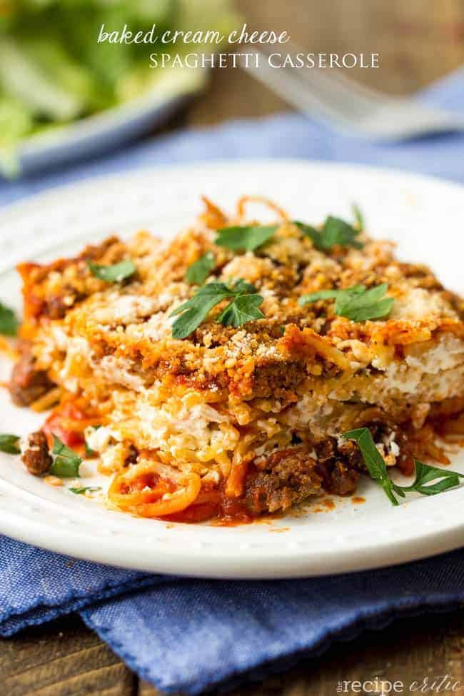 An easy delicious baked spaghetti with cream cheese baked inside! A meal that the entire family will love! Baked cream cheese spaghetti casserole on a white plate.