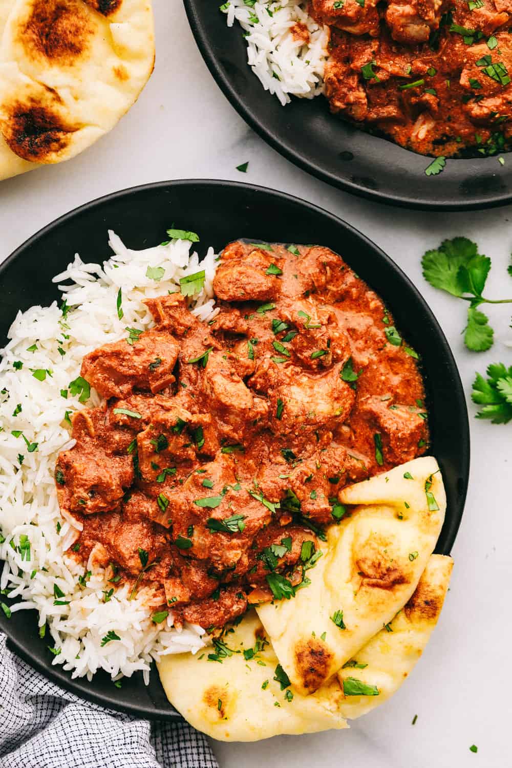 Chicken Tikka Masala is an easy, sweet and spicyย sauce thatย is thick, rich and creamy with an intense color of orange and red blend that hasย several spices blendedย together with creamy yogurt covering cubes ofย chicken breasts leaving you with an intense flavor all served over rice. ย Let the slow cooker do all theย work! Chicken tikka masala with rice and naan bread on the side.