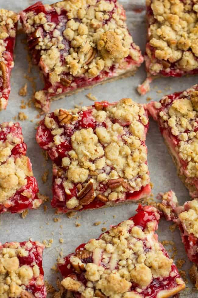 Delicious Cherry Pie Bars swirled with a creamy sour cream center and taste like a cherry pie in each and every bite! Cherry Pie Bars sliced in pieces.
