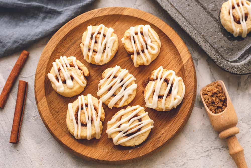 Cinnamon Roll Cookies are a sweet and savory cookie, rolled in a cinnamon buttery filling bakedย until puffy thenย drizzled with a sweet glaze frosting. Theseย holiday cookies won't last long! Cinnamon Roll Cookies