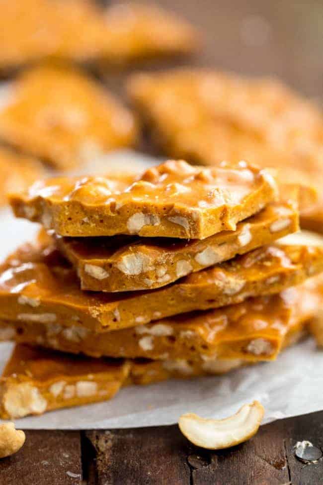 This brittle was made right in the microwave and I couldn't believe how easy it was. It tasted just like I slaved hours over the stove making this with a candy thermometer. Nobody would ever know! Cashew Brittle stacked on top of each other and on parchment paper.