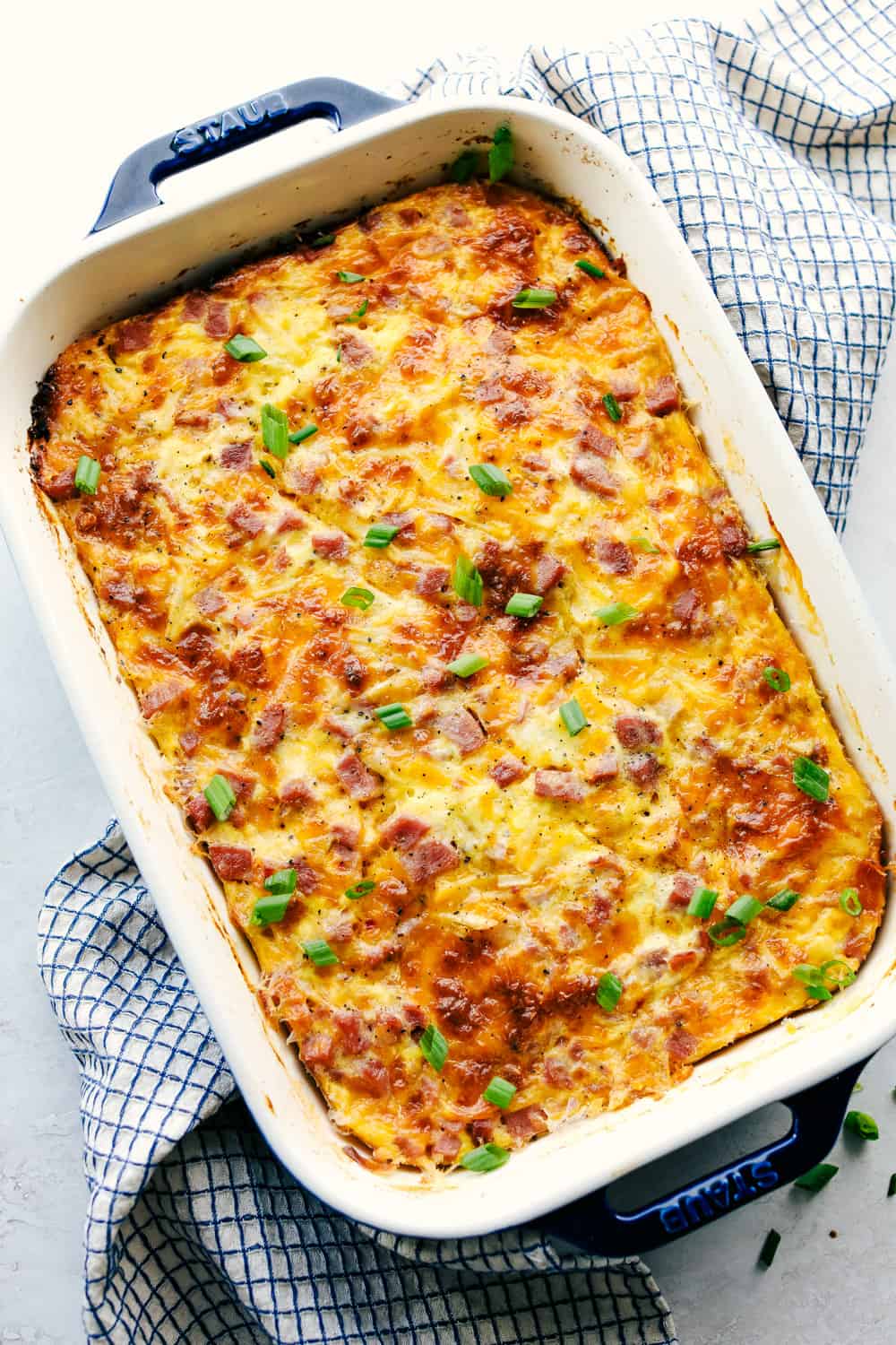The Best Breakfast Casserole is a thick and creamy egg base with shreddedย potatoes, chunks of ham and flavorful cheese blends that bakes up in no time. Make ahead or enjoy the morning of during the holidays! Breakfast casserole baked in a casserole dish.