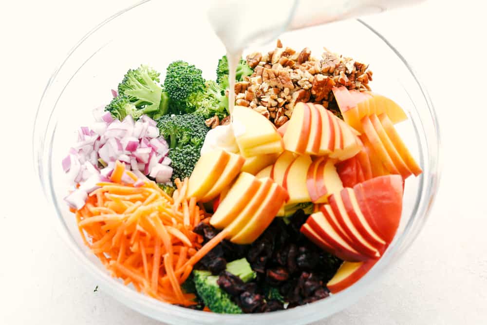 Broccoli, pecans, cranberries, carrots and apples come together to make an amazing salad with delicious flavors and textures. The creamy dressing on top makes this salad absolutely incredible! Pour the dressing over the salad ingredients.