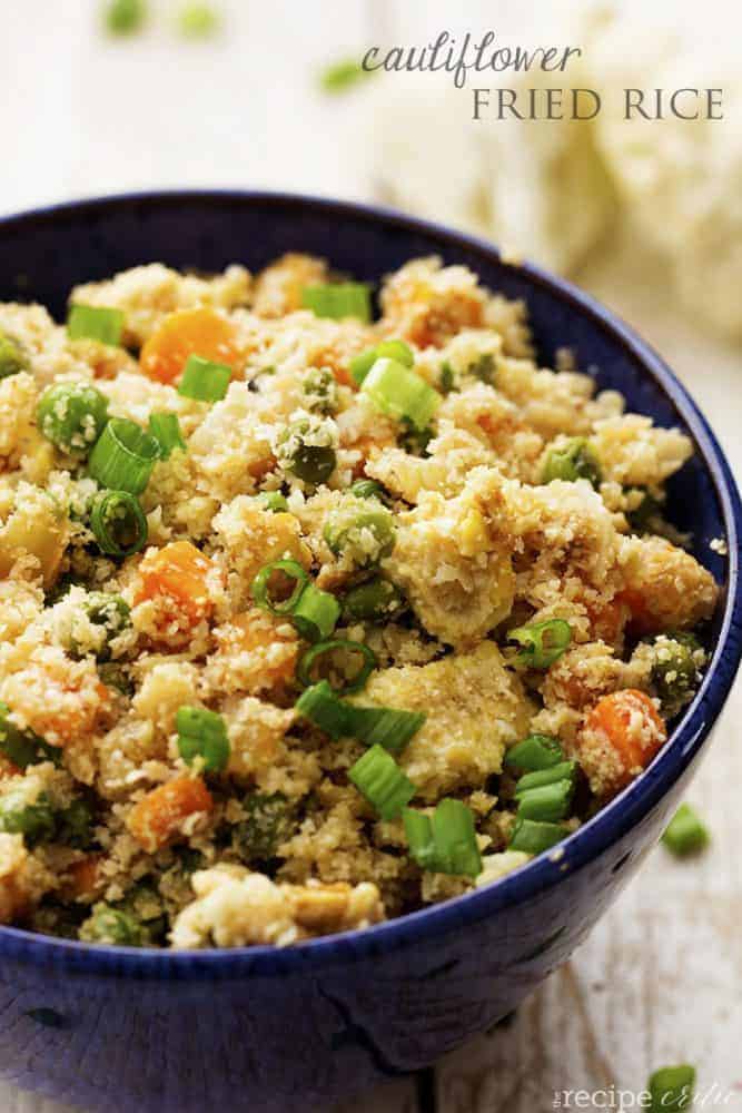 Looks and tastes exactlyย like fried rice! But so much healthier for you! Tastes amazing plain, or would also be great with some ham, chicken or meat added! Cauliflower fried rice in a blue bowl.