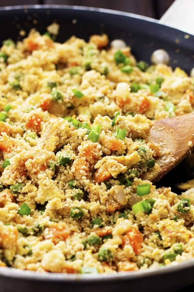 Looks and tastes exactlyย like fried rice! But so much healthier for you! Tastes amazing plain, or would also be great with some ham, chicken or meat added! Close up view of cauliflower fried rice.