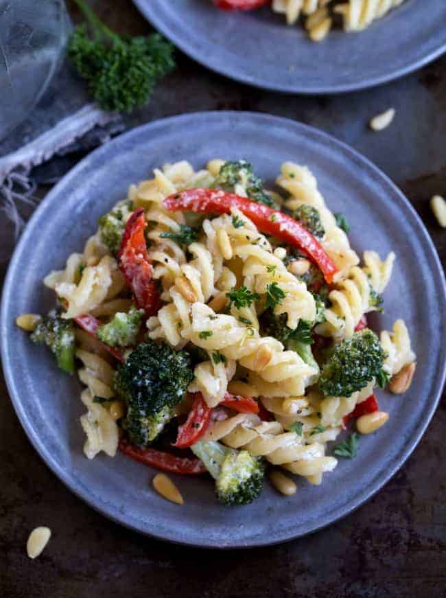 I’ve got a fancy-sounding, but secretly SUPER simple dish. It’s a classy dressed-up pasta, but couldn’t be too much easier to make! Goat Cheese Pasta on a blue plate.