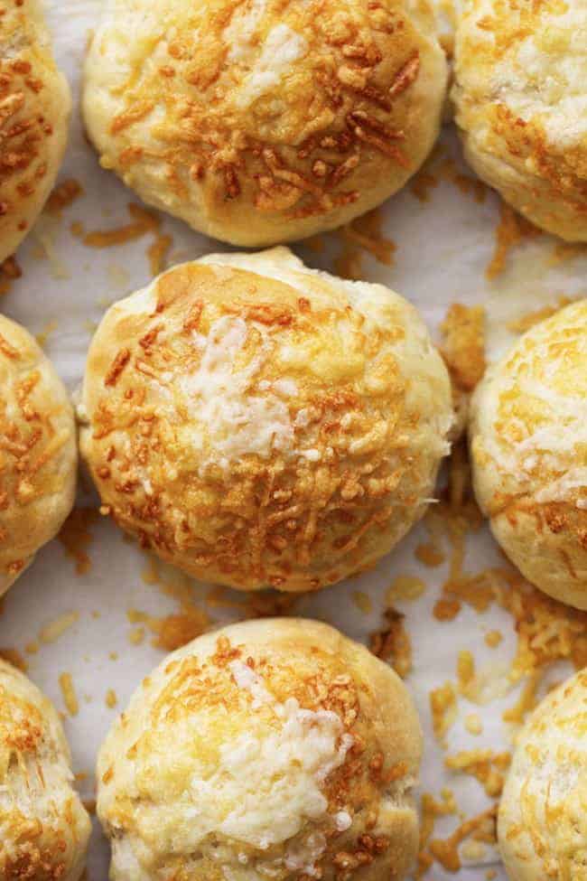 I could have probably eaten the entire batch if my kids would have let me. But instead, they grabbed them all as soon as they came out of the oven! asiago cheese rolls fresh out of the oven on a sheet pan.