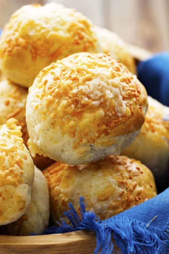 You guys are going to love these rolls. Fast. Easy. And so delicious with that wonderful cheese! You will make them again and again! asiago cheese rolls in a basket ready to be served.