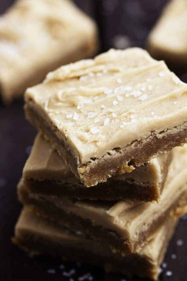 Delicious chewy sugar cookie bars made with brown butter. This adds such amazing flavor and the salted caramel buttercream on top is the best part! Stack of brown butter sugar cookie bars