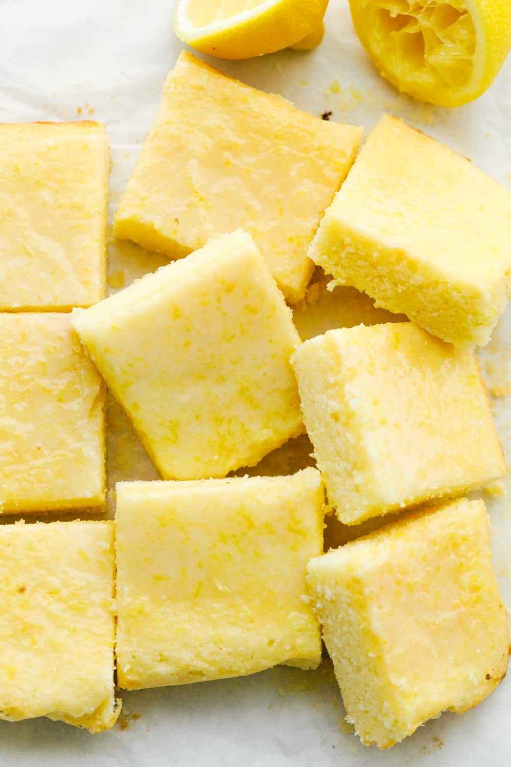 Quick and easy lemon brownies that are perfectly moist and chewy! The Lemon Glaze on top is the perfect finishing touch! It will be hard to stop at one! Lemon Brownies cut into squares ready to eat.