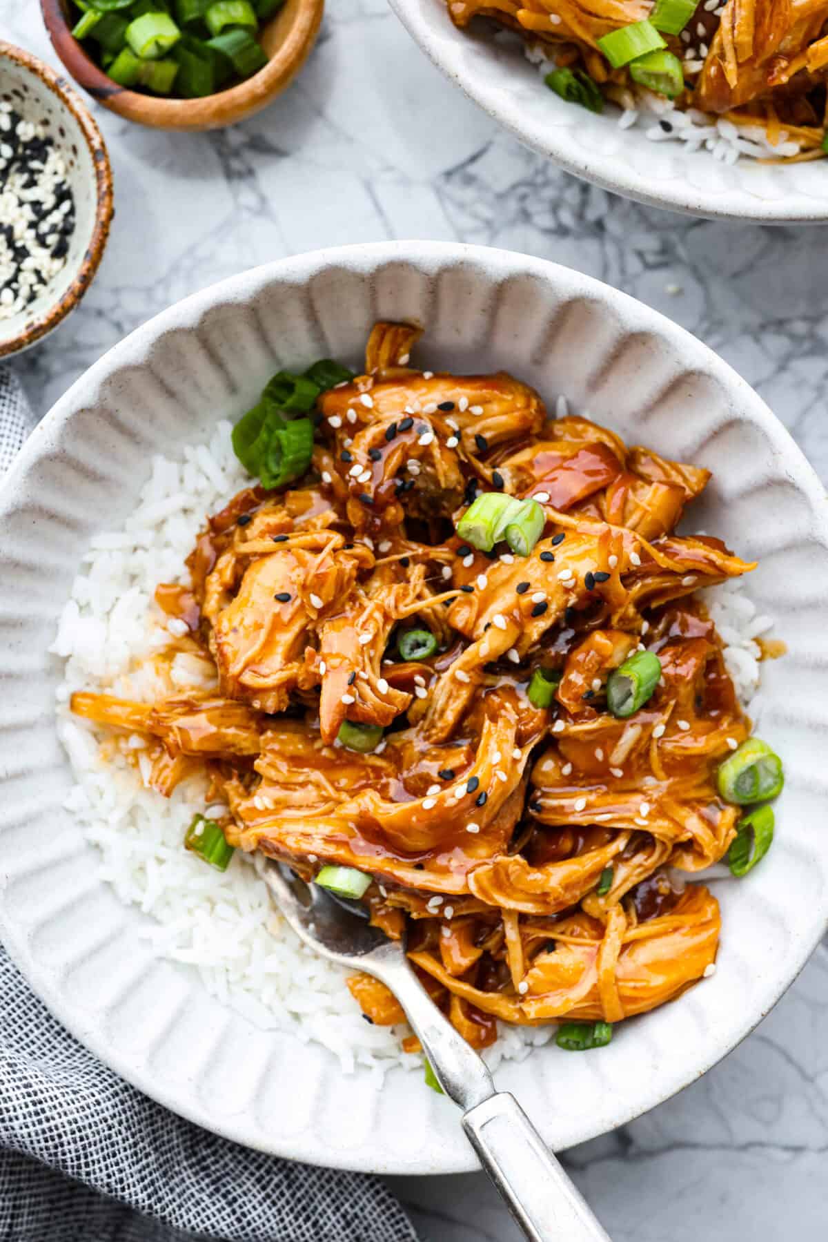 This slow cooker honey teriyaki chicken is so easy to throw together, and the flavor is out of this world! The chicken cooks to perfection and will be one of the best things you'll ever make! Overhead shot of plated slow cooker honey teriyaki chicken.
