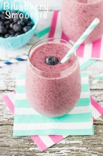You have to try this blueberry smoothie! Blueberry Smoothie in a glass with a blue and white striped straw by Deliciously Sprinkled