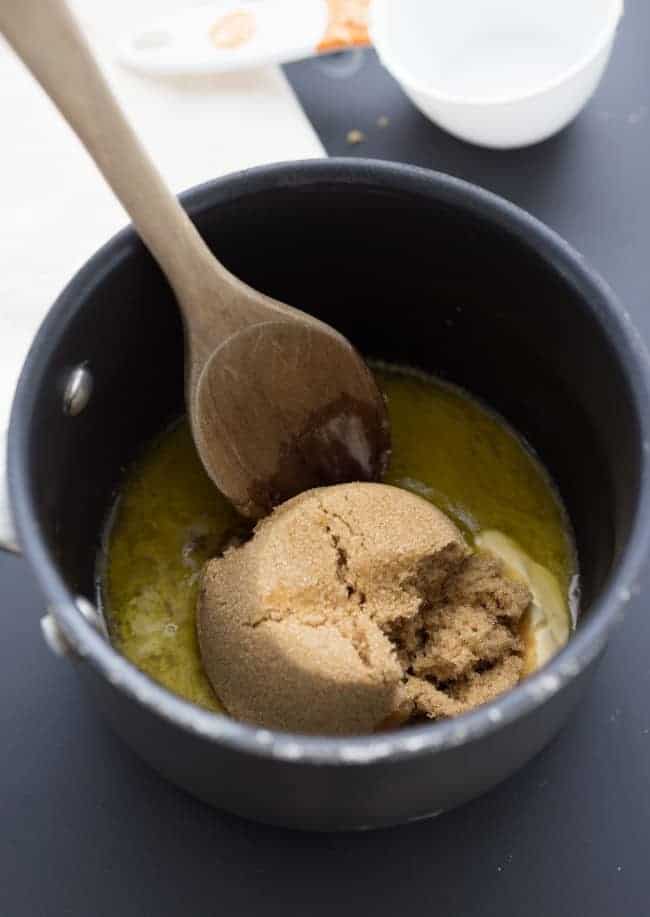 This salted caramel sauce is so simple to make and includes very easy ingredients. There aren't too many steps, but if you follow them exactly, you'll have a gorgeous caramel sauce in no time! Brown sugar and butter in a large pot with a wooden spoon.