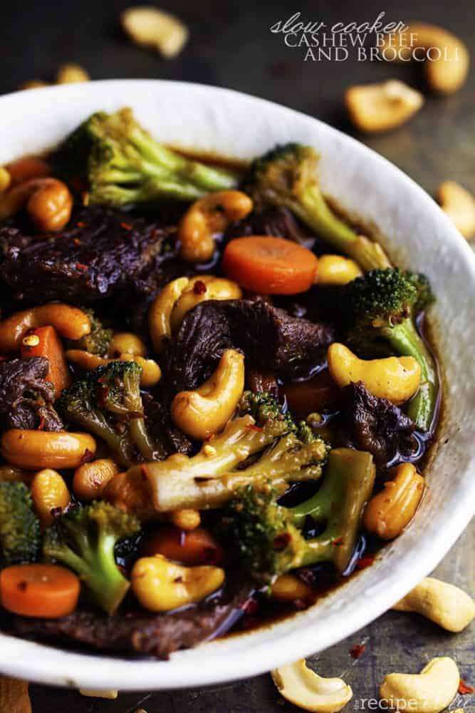 Delicious melt in your mouth beef that cooks right in your slow cooker with veggies and cashews hidden throughout. One of the best meals that you will make in your slow cooker and so much better than takeout! cashew beef and broccoli in a white bowl