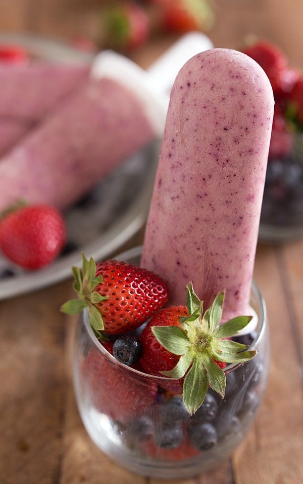 These pops are made SUPER easy. Just blend up the ingredients, put them in a popsicle maker, and freeze. Frozen Greek Yogurt and Fruit Pops - healthy and delicious!