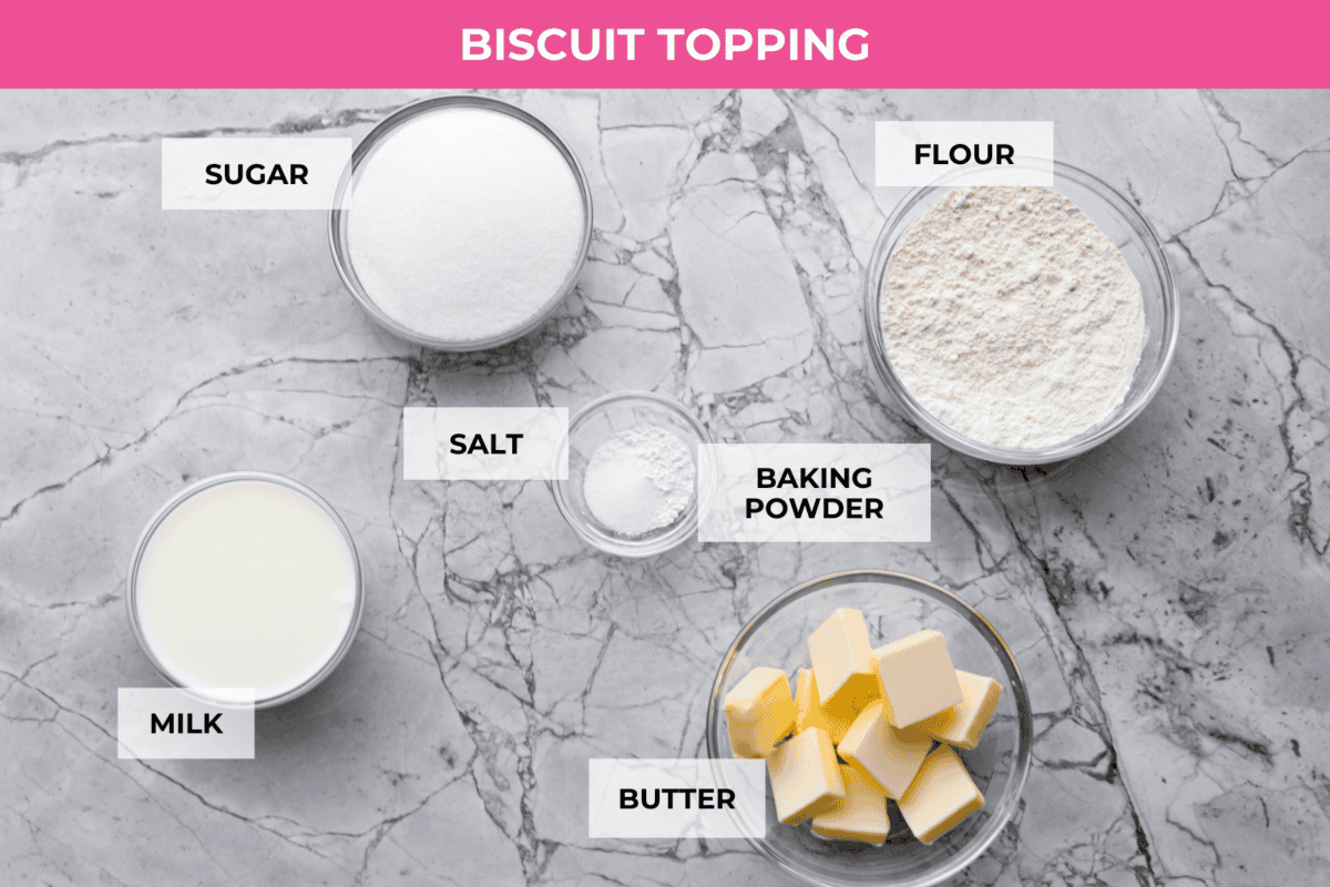 Old-fashioned peach cobbler is a timeless summer dessert! Its warm, cakey layers baked with freshly sliced peaches are a match made in heaven. Top the cobbler with vanilla ice cream, and every bite will be a delight! Overhead shot of labeled biscuit topping ingredients for peach cobbler.