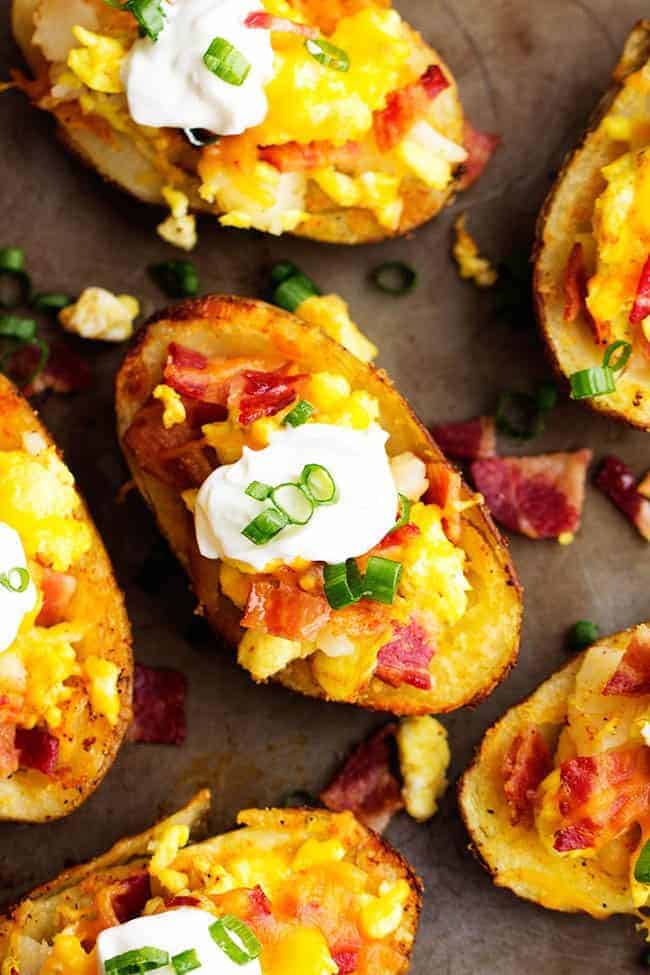 Seasoned crispy potato skins get loaded with potatoes, eggs, bacon and cheese. Topped with all of your favorite toppings, these will become a family favorite! potato skins areal view.