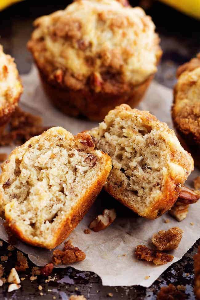 Moist and delicious banana muffins with a crumbly cinnamon streusel topping. This is such a yummy way to use up those over ripe bananas! banana bread muffins cut in half.