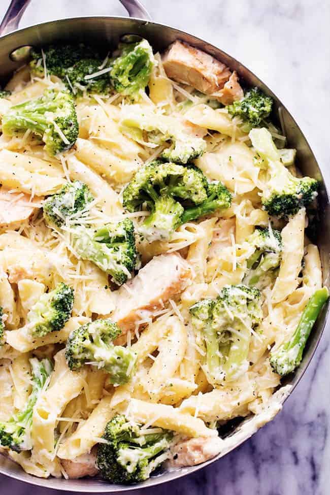 Delicious homemade three cheese alfredo gets tossed with pasta, broccoli and chicken. It is quick and easy and out of this world good! It will become an instant favorite! three cheese chicken broccoli alfredo in a pot.