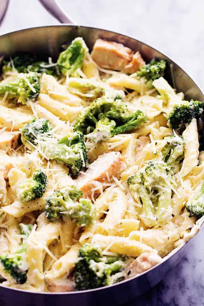 Delicious homemade three cheese alfredo gets tossed with pasta, broccoli and chicken. It is quick and easy and out of this world good! It will become an instant favorite! Three cheese chicken broccoli alfredo in a pot.