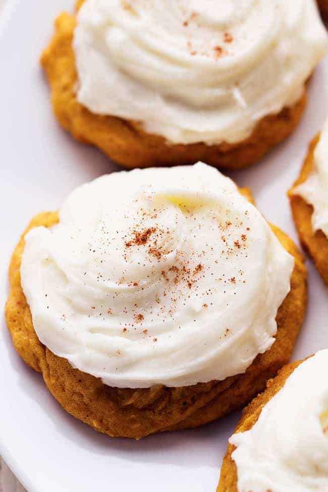 Delicious and soft pumpkin cookies that just melt in your mouth! These are the BEST pumpkin cookies and the cream cheese frosting on top is fantastic! Close up on pumpkin cookies.