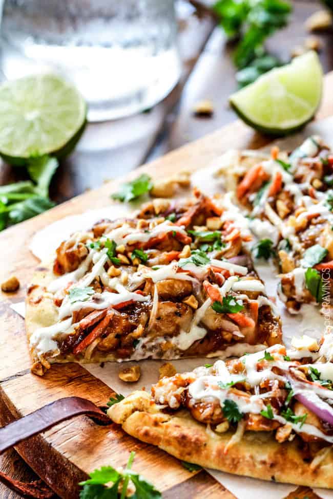 Thai Chicken Flatbread Pizza smothered in easy tangy peanut sauce, tender chicken, ย carrots, sprouts, mozzarella cheese and the option of Coconut Crema drizzle - an amazing flavor bursting quick dinner the whole family will love! CPK inspired 20 Minute Thai Chicken Flatbread Pizza smothered in easy tangy peanut sauce, tender chicken, mozzarella cheese, crunchy carrots, sprouts and peanuts and the option of creamy coconut yogurt drizzle - an amazing flavor bursting quick dinner at a fraction of the cost.