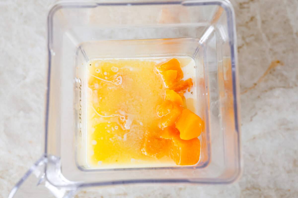 This cheesy butternut squash pasta recipe is loaded with cozy fall squash and ooey, gooey cheese,ย making it a perfect meal to warm up to on crisp fall evenings. Even better, it can be ready in less than an hour! Overhead shot of the squash, melted butter, milk, half and half in a blender.
