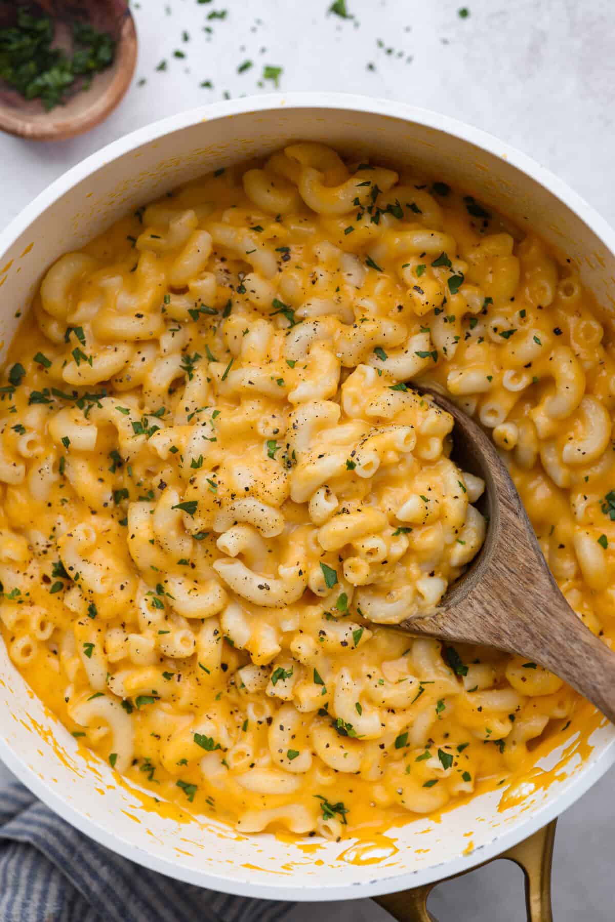 This cheesy butternut squash pasta recipe is loaded with cozy fall squash and ooey, gooey cheese,ย making it a perfect meal to warm up to on crisp fall evenings. Even better, it can be ready in less than an hour! Over head shot of cheesy butternut squash pasta in a pot.