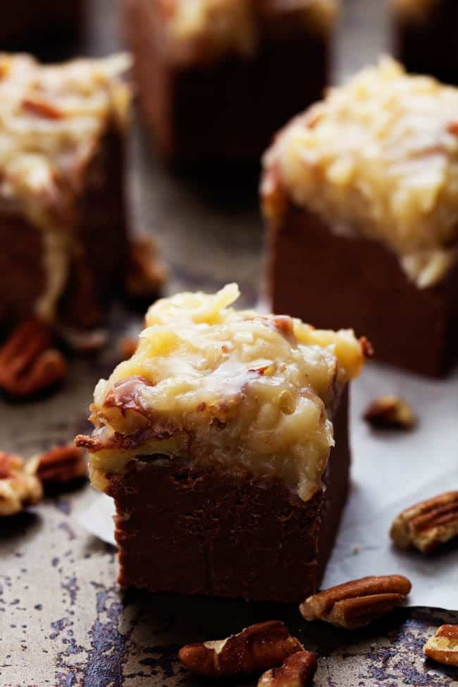 A quick and easy chocolate fudge that doesn't require a thermometer. Topped with the signature coconut pecan frosting, this fudge is out of this world!ย german chocolate fudge square close up.