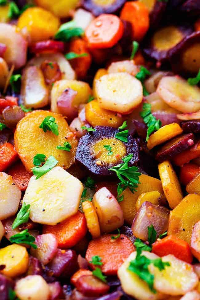Vibrant colored rainbow carrots get sautéed in brown butter and garlic creating a delicious side dish. They are so tender and flavorful and will become a favorite new side! rainbow carrots close up.