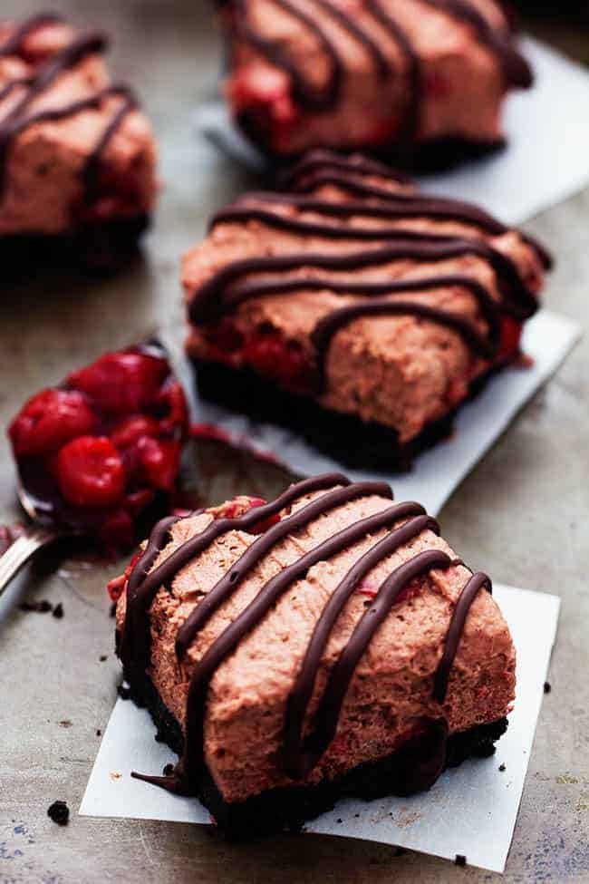 Delicious light and fluffy chocolate mouse with hidden cherries busting inside. This dessert is rich and creamy on top of an oreo crust and drizzled in chocolate. It will become an instant favorite with the first bite! Chocolate Cherry Mousse Bars