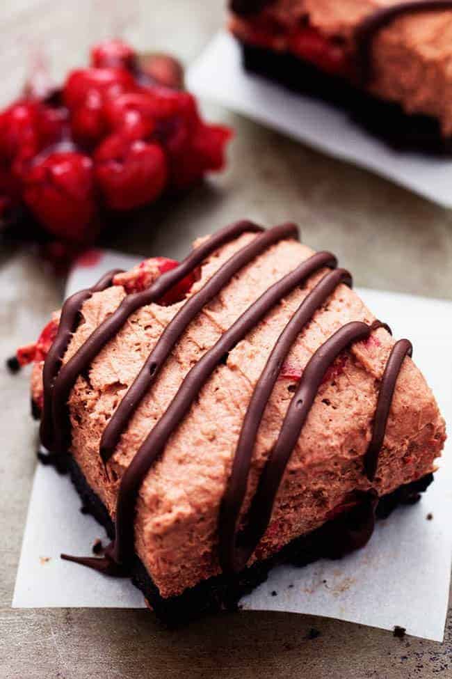 Delicious light and fluffy chocolate mouse with hidden cherries busting inside. This dessert is rich and creamy on top of an oreo crust and drizzled in chocolate. It will become an instant favorite with the first bite! Chocolate Cherry Mousse Bars