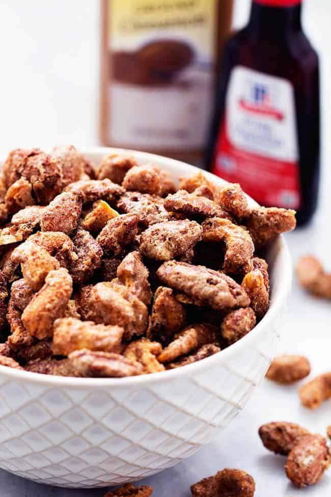 These are unbelievably good. I love that I can make my own at home now! Roasted cinnamon sugar nuts in a white bowl.