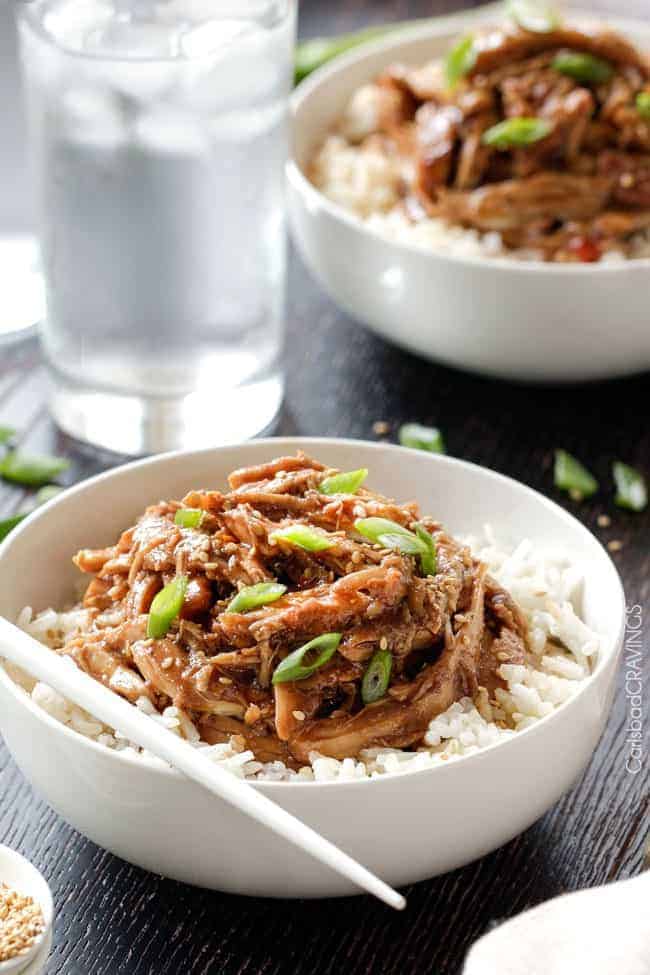 Slow Cooker Honey Soy Chicken is so easy and so delicious you will be wondering how you ever lived without it! Honey Soy Chicken over rice in white bowl.