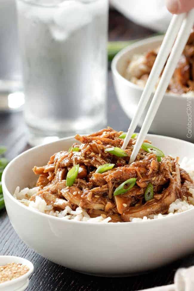 Slow Cooker Honey Soy Chicken is so easy and so delicious you will be wondering how you ever lived without it! Honey soy chicken over rice in white bowl.