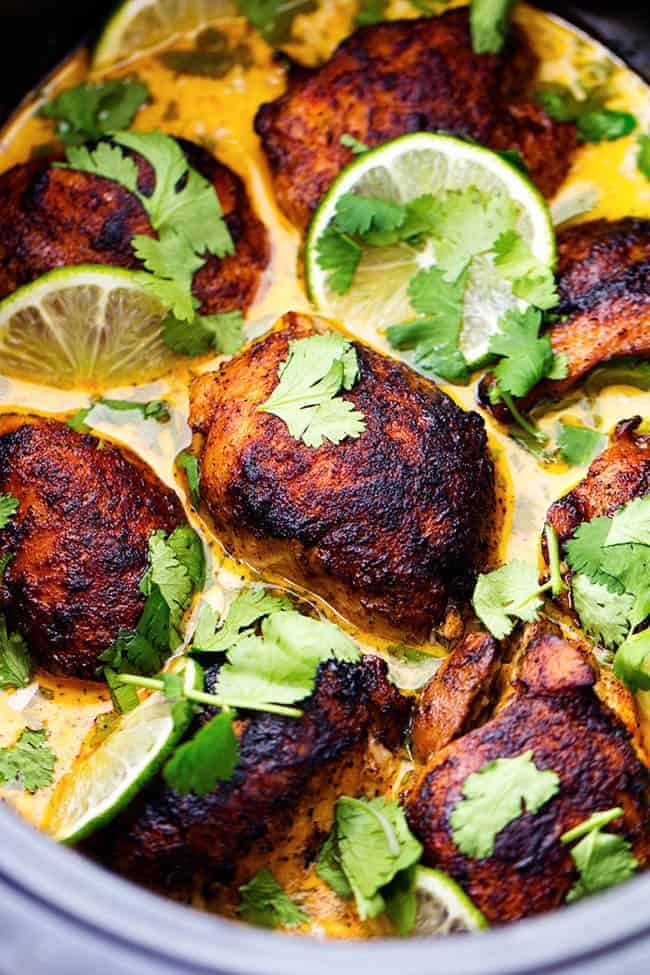 Tender and juicy seasoned and pan seared chicken thighs slow cook with a flavorful and light cilantro lime sauce. ย This meal is packed with flavor and absolutely delicious!ย Slow Cooker Creamy Cilantro Lime Chicken.