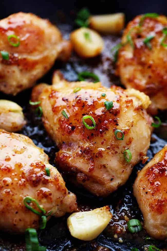 A quick and easy 30 minute meal that is packed with amazing honey dijon garlic flavor! The chicken is so juicy and tender and the sauce is sweet and tangy... you are going to love it! Chicken in frying pan with garlic and onion.