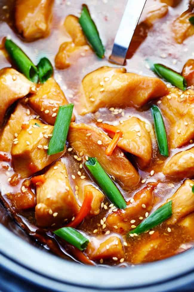 This Slow Cooker Mongolian Chicken takes just five minutes to throw into the slow cooker and the flavor is out of this world! Tender and juicy slow cooked chicken in a lightened up mongolian sauce that is sure to wow your family! Mongolian chicken with green onions in a slow cooker.