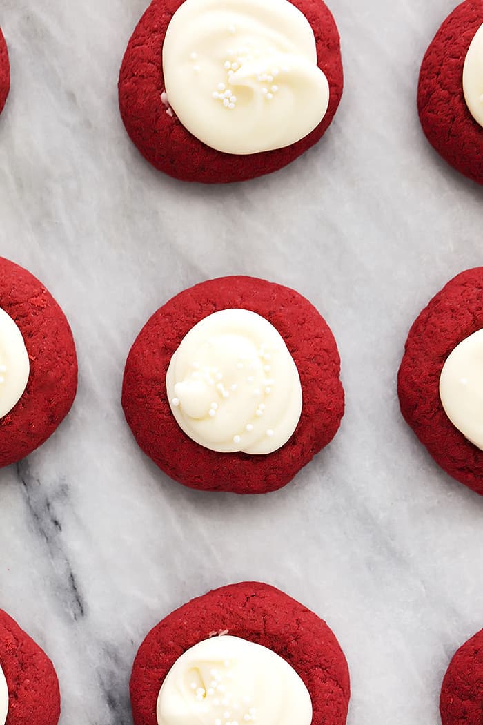 These thumbprint cookies are buttery pillows of dreamy cookie goodness filled with rich cream cheese frosting and I have eaten WAY too many of them. Red velvet cookie with cream cheese filling.