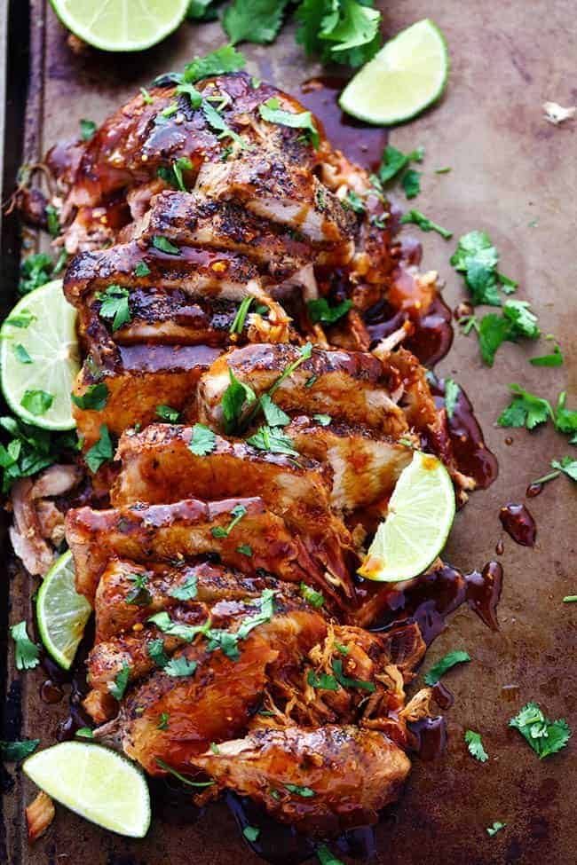 Delicious and tender pork cooked in the slow cooker with a honey, lime, soy, garlic, and ginger infused marinade. We loved it so much we had it twice in one week! Slow cooker honey lime ginger pork sliced up with fresh cut limes on the side.