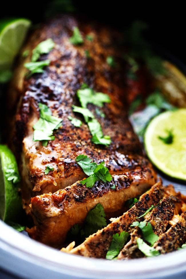 Delicious and tender pork cooked in the slow cooker with a honey, lime, soy, garlic, and ginger infused marinade. We loved it so much we had it twice in one week! Close up photo of slow cooker honey lime ginger pork in a dish.