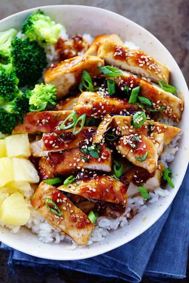 A sweet teriyaki sauce infused with pineapple and ginger bringing such an amazing marinade for this chicken! ย A quick 30 minute meal that you will make again and again!ย Teriyaki Chicken with broccoli, pineapple and rice in a bowl.