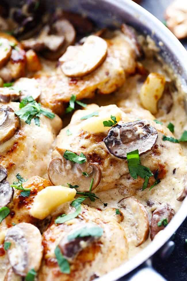 Tender and juicy chicken in the most amazing creamy and delicious garlic mushroom sauce! This makes one incredible 30 minute meal! Creamy garlic mushroom chicken in frying pan.