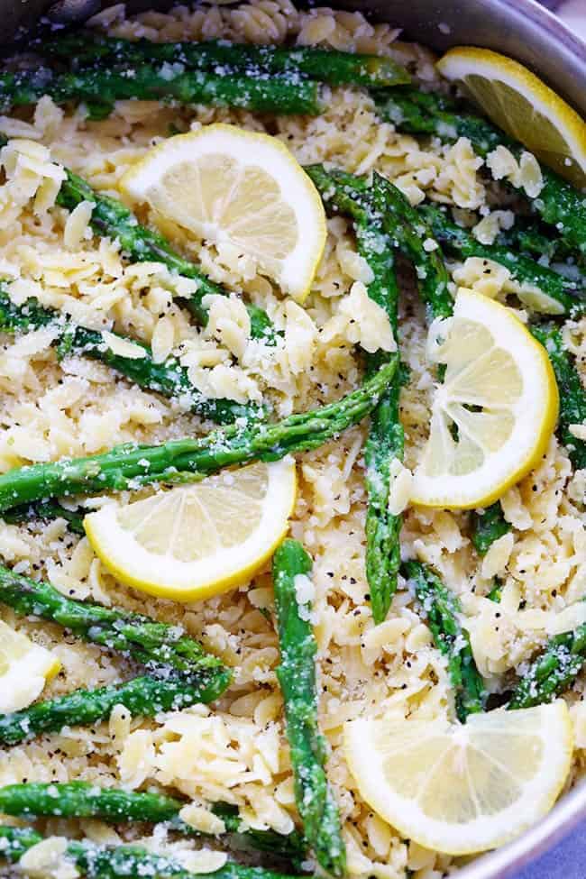 A buttery lemon parmesan garlic sauce coats orzo pasta and gives it such amazing flavor! It gets tossed with asparagus and makes one delicious meal! Close up photo of Lemon Parmesan Garlic Orzo with Asparagus.