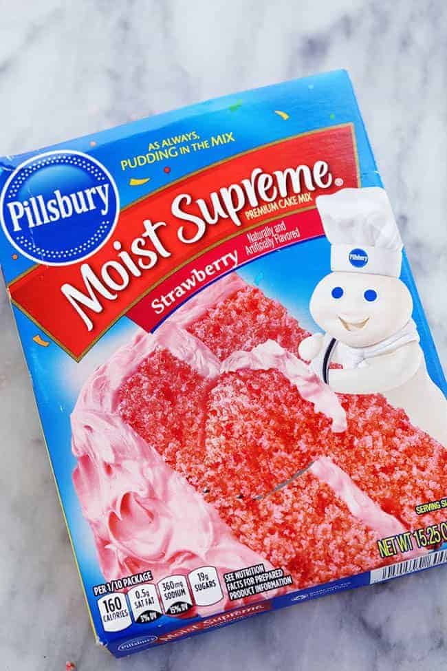 A delicious and moist strawberry coconut cream cake with an amazing coconut cream cheese frosting! Pillsberry moist supreme strawberry cake mix.