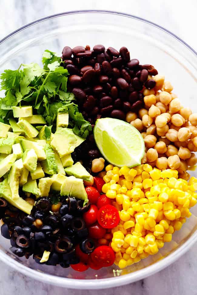 Southwest Chickpea Salad is a delicious and fresh chick pea salad filledย so many delicious flavors and textures! ย This salad is fresh and healthy and easy to make! southwest chickpea salad ingredients in a bowl