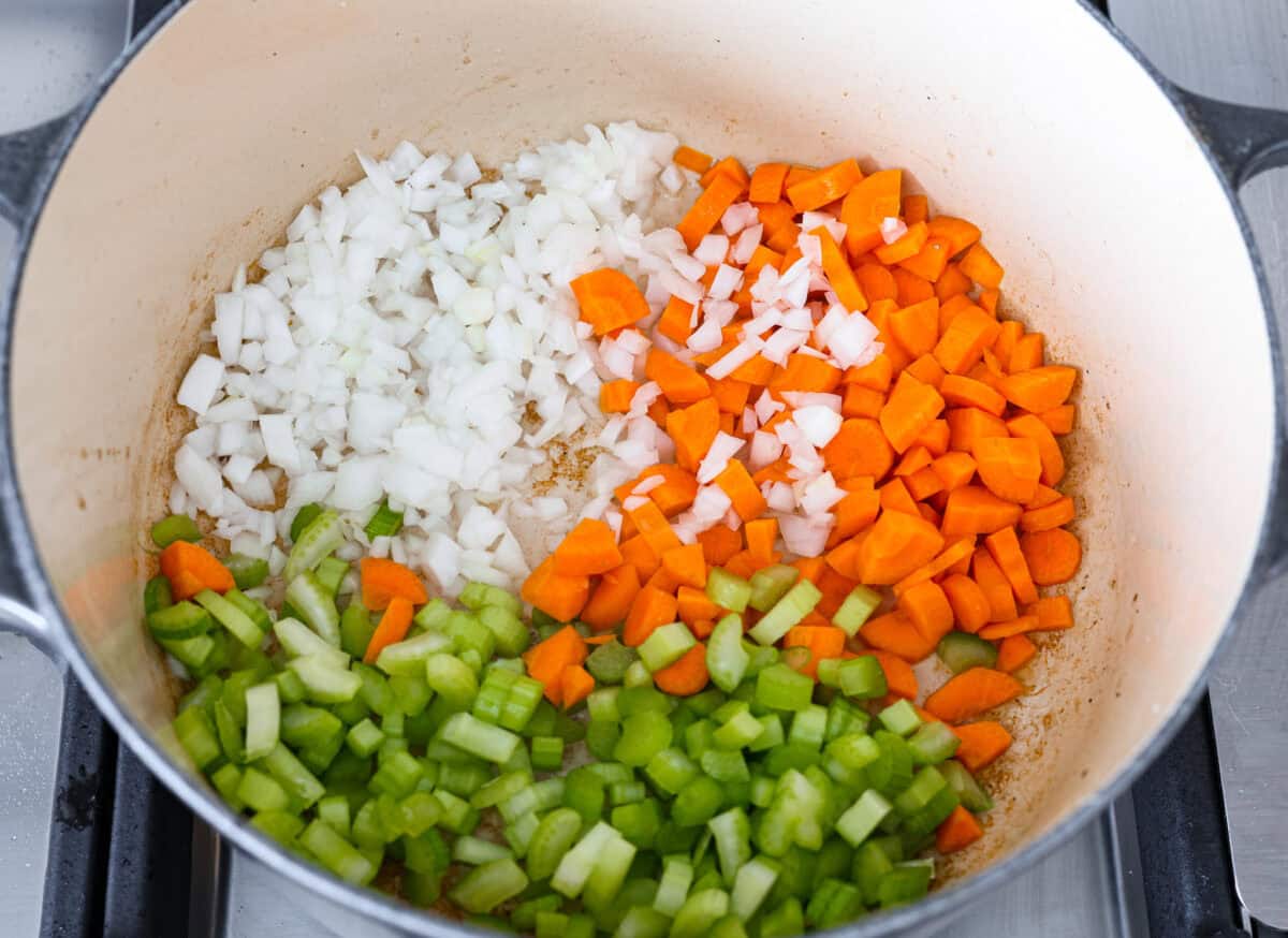 This hearty Vegetable Beef Soup is comforting and flavor-packed! It's loaded with beef, potatoes, and veggies that simmer to tender perfection. A classic and easy one-pot soup for a chilly night. Second photo of the veggies added to a large pot.