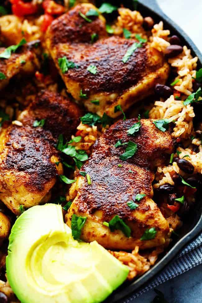 An amazing one pan meal with tender and juicy cajun blackened chicken over delicious southwest rice! This meal became an instant favorite at our house! One Pan Southwest Blackened Cajun Chicken with Rice with fresh cut avocado in a large skillet.