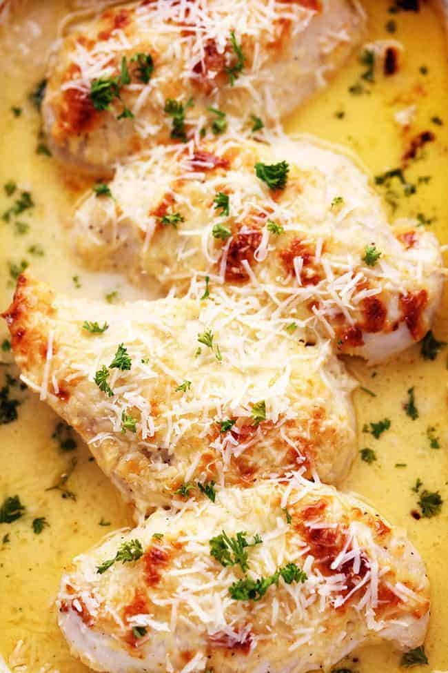 An amazingly creamy baked chicken with asiago cheese inside. It comes together quickly and will be loved by the entire family! Close up of creamy baked asiago chicken.